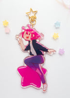 Colorful ADHD Alien acrylic charm with pink hair and a star on a white background