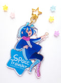 Keychain with character design labeled 'Space Traveler' on a white background
