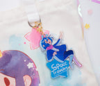 Keychain with a 'Space Traveler' text and ADHD Alien character on a soft, light-colored background