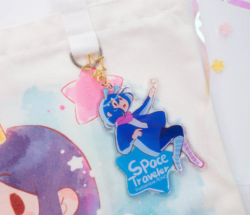 Keychain with a 'Space Traveler' text and ADHD Alien character on a soft, light-colored background