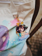 ADHD Alien character keychain attached to the alien totebag with a blurred background