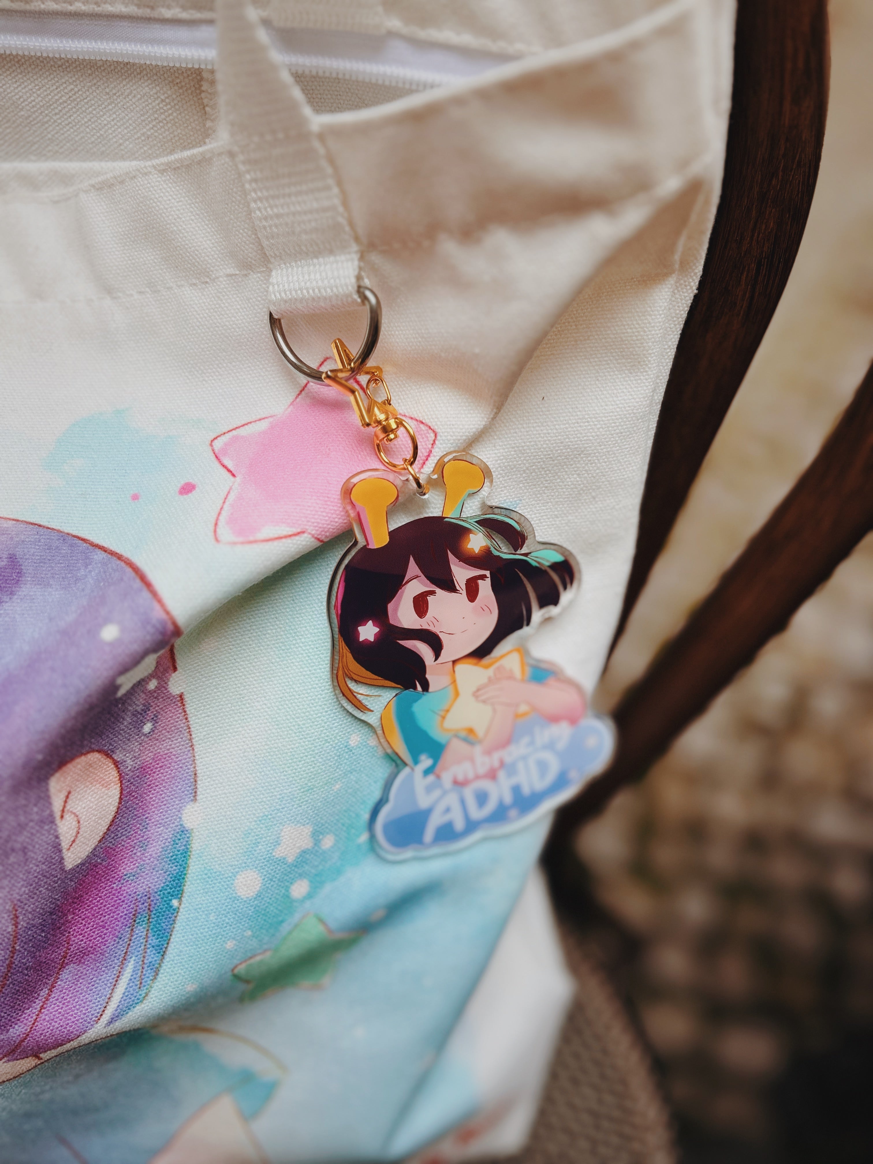 ADHD Alien character keychain attached to the alien totebag with a blurred background