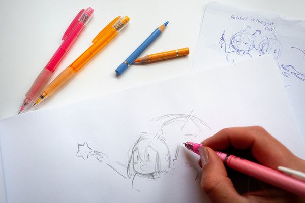 Hand drawing ADHD Alien designs with colored pens on a white sheet of paper - Making of image 1