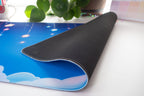 Desk mat folded over to reveal the rubber backside on a white background