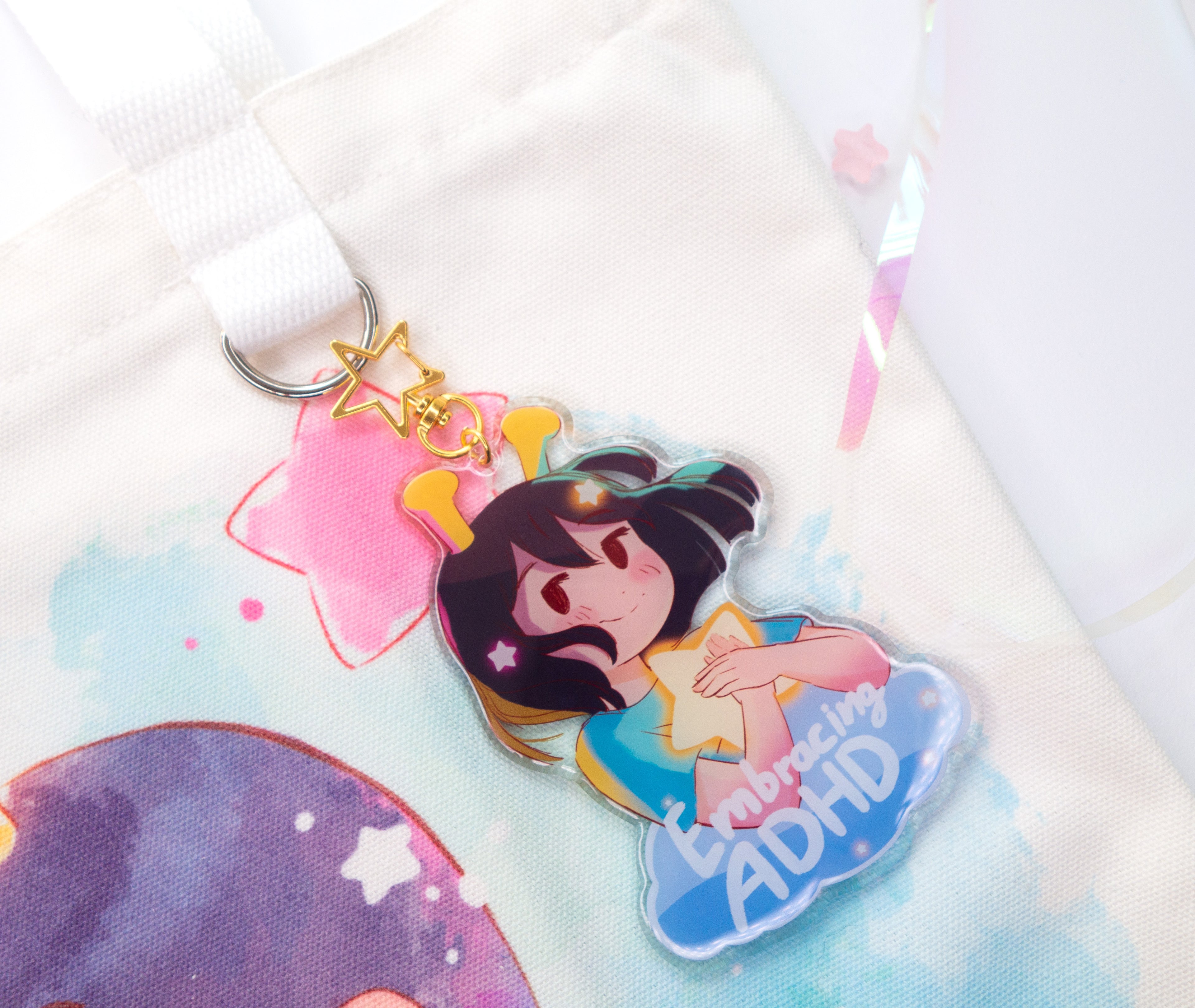 Colorful keychain with the ADHD Alien character and text on a white background