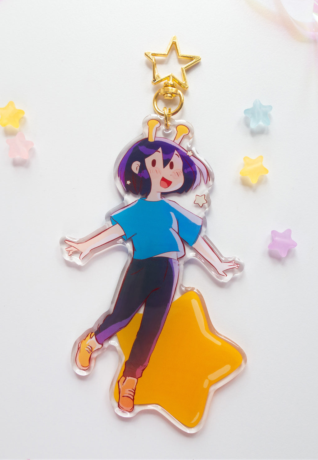 ADHD Alien acrylic charm backside design on a star-shaped base with colorful stars in the background