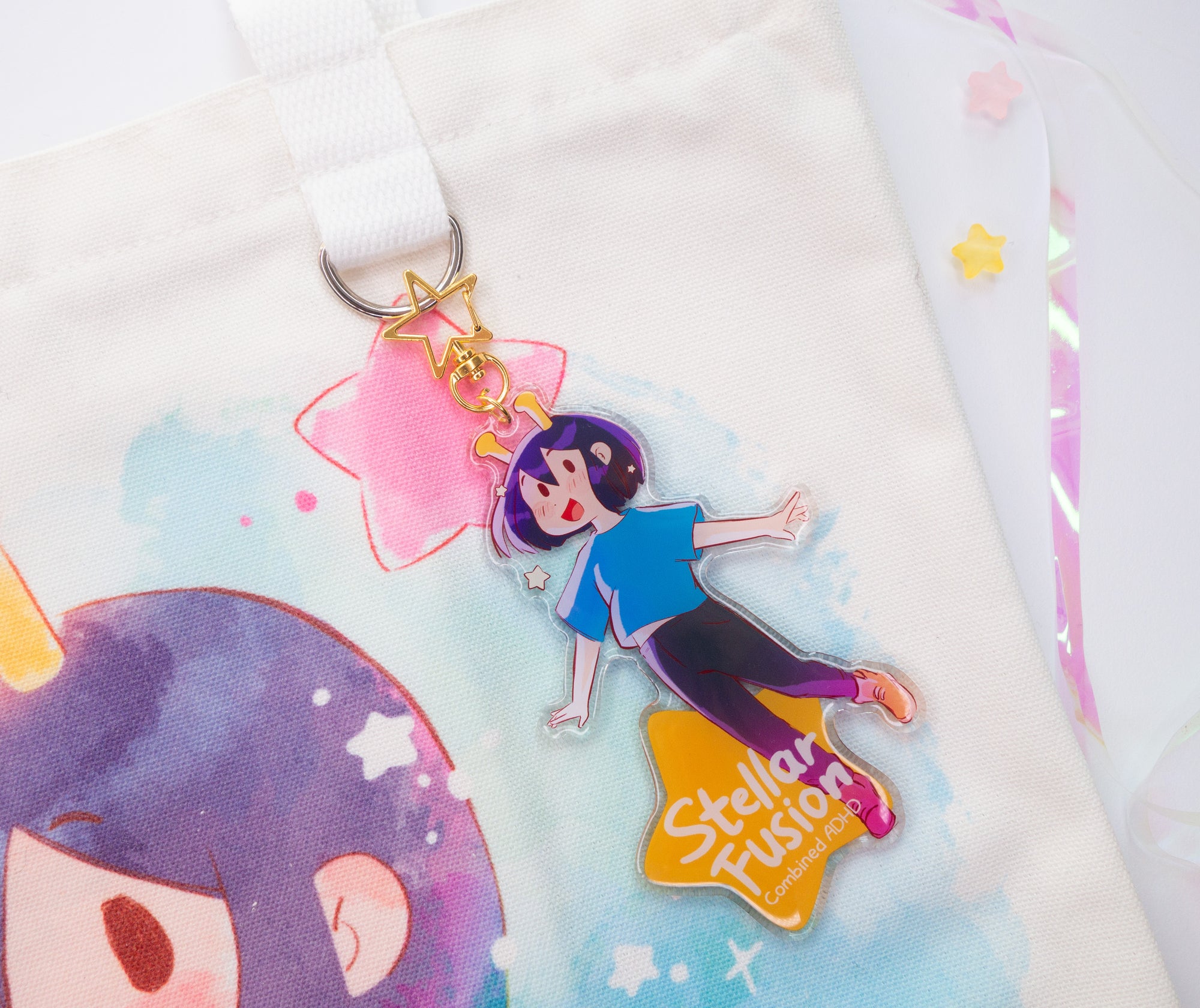 Colorful keychain with ADHD Alien character design and golden star clasp on a soft white background