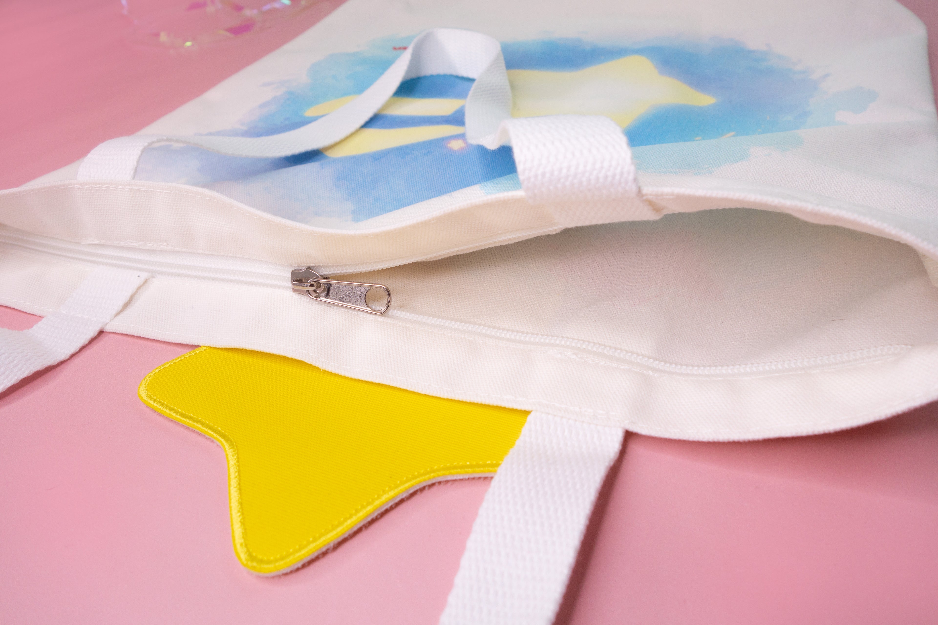 Back design of the tote bag with colorful design on a pink background