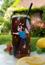 Tumbler with ADHD Alien character print filled with iced tea, surrounded by lemons and strawberries outdoors.